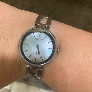 Two citizen watches, one black and one opal